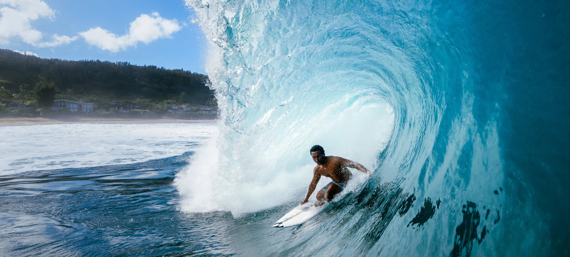 Josh Moniz slides through a crystal blue barrel at Pipeline.
